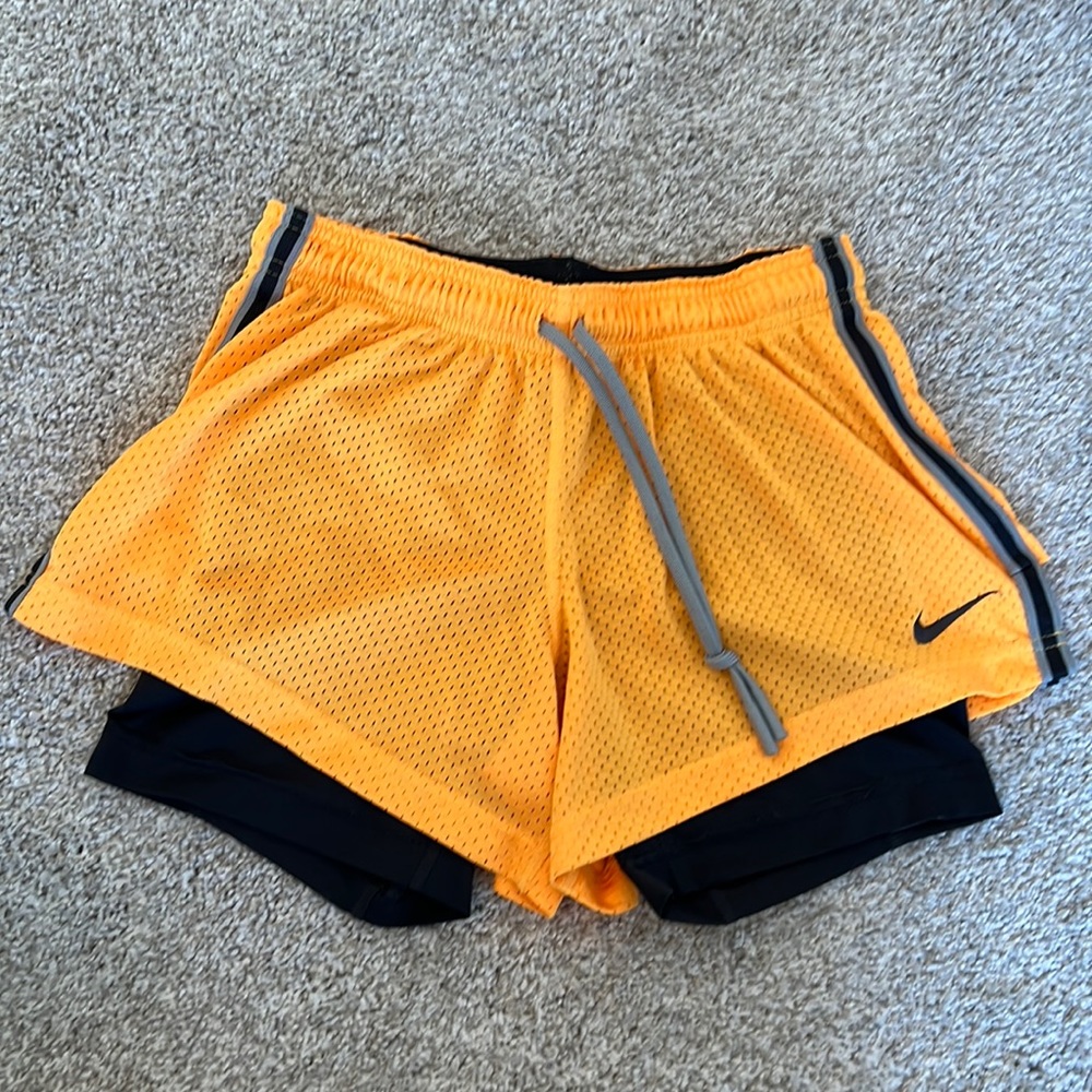 Nike orange running/cycling shorts with spandex inner shorts. Size small.
